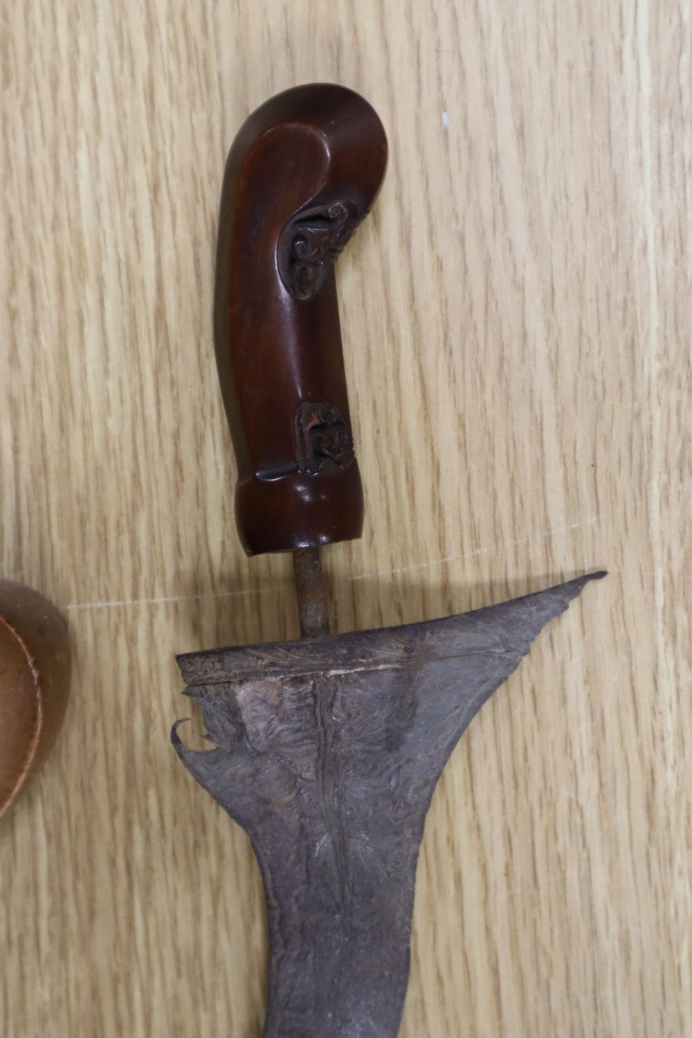 A 19th century Javanese kris, with 14 inch blade, two other edged weapons and a ceremonial head-dress